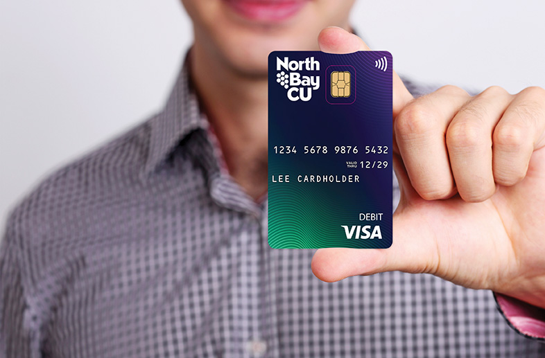 man holding Visa Debit Card