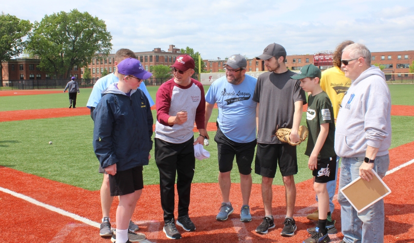 Dan Moriarty gets ready to flip a coin to decide which team will be up to bat first.