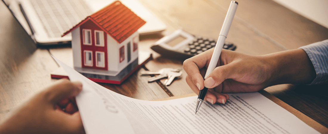 A person signing a mortgage