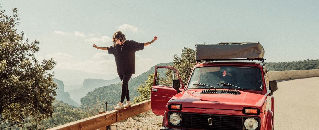 Woman balancing on car