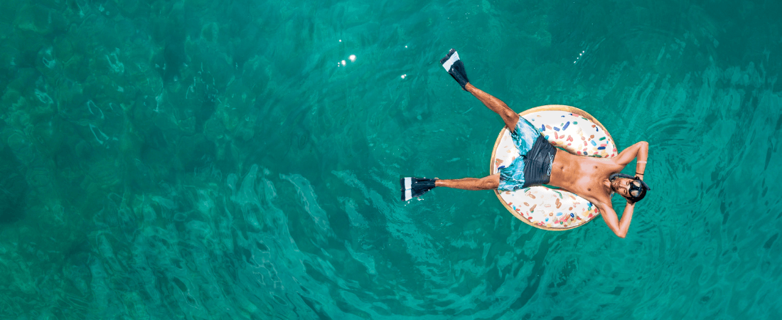 Vacation - a man floating in a pool