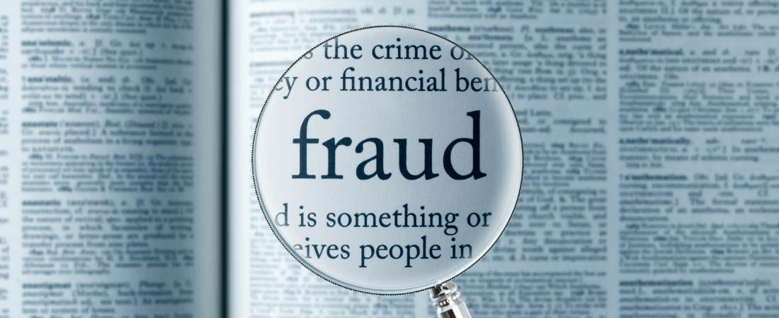 Magnifying glass over the word fraud
