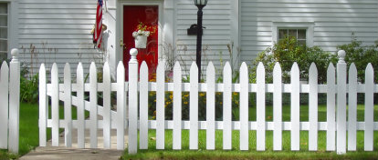 Image of a picket fence in front of a house
